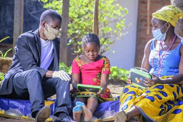 Parents and child using educational tablet